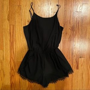 Aqua black romper with lace trim around hem